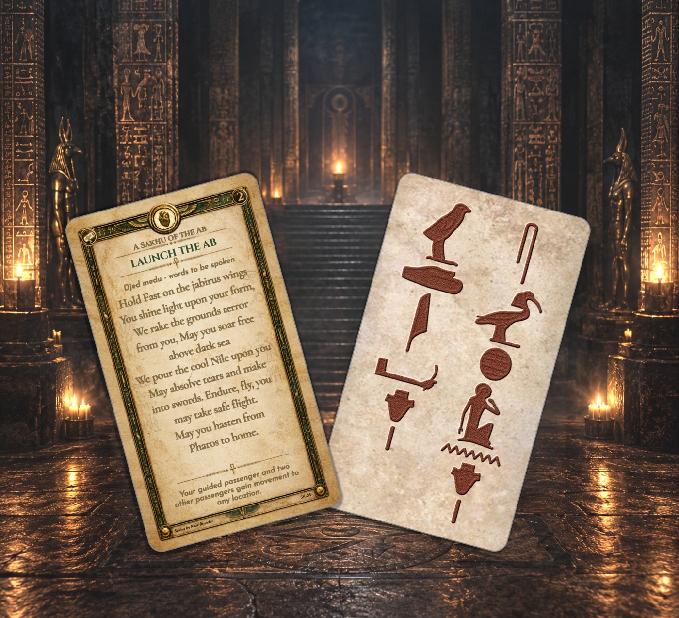 Pixie Bruner's Sakhu card Launch the Ab, a parchment card with a heart emblem and gold Egyptian border, shown beside its hieroglyph-carved stone back in a candlelit Egyptian temple hall